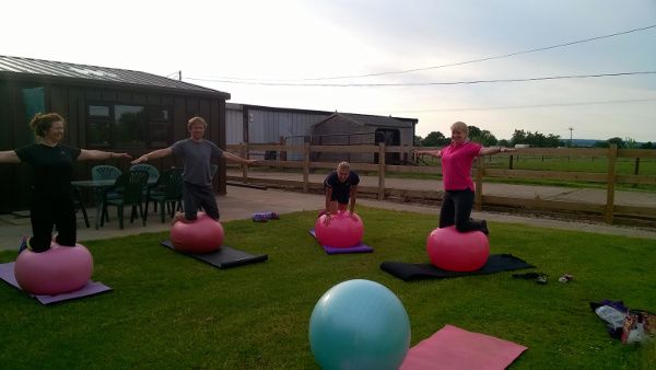 Balancing on fitballs outside at Lincomb Camp